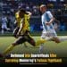 A Dortmund player leaps to control the ball on the football pitch during a match