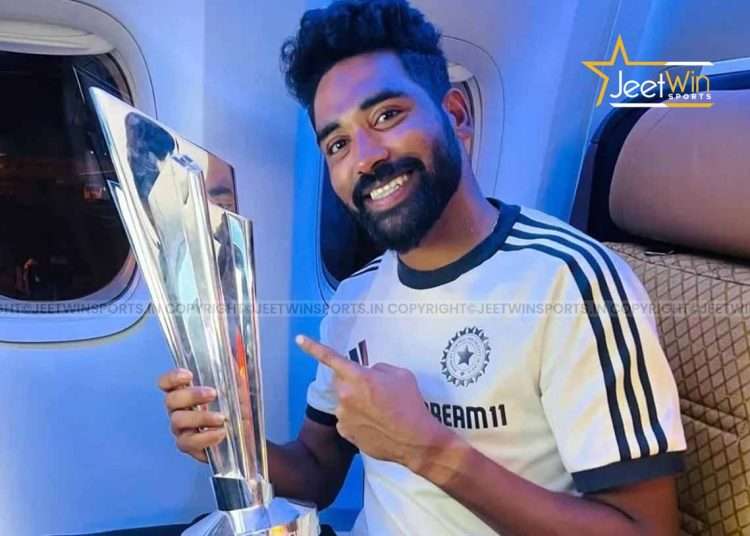 Mohammed Siraj holding trophy