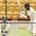 cricketers ready to hit ball and wicketkeeper in back