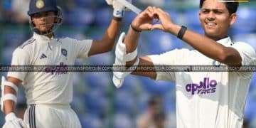 Cricketer making a love sign while posing for a photo on the cricket field