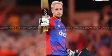 Cricket player raising a bat