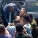 Anthony Joshua Injured in Nigeria Car Crash That Killed Two Team Members 6 Several people helping and carrying an injured person from a car crash scene