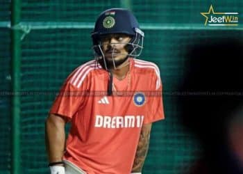 Cricketer on the field wearing a helmet