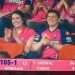 Couple watching a match and clapping