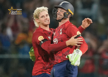 Cricket players hugging each other.